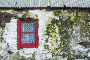 Wall Mural - detail of red window on old weathered farmhouse in north county Kerry, Ireland