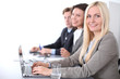 © rogerphoto - A group of business people at a meeting on the background of office. Focus on a beautiful blonde