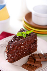 Sticker - Chocolate cake with chocolate cream on plate, on light background