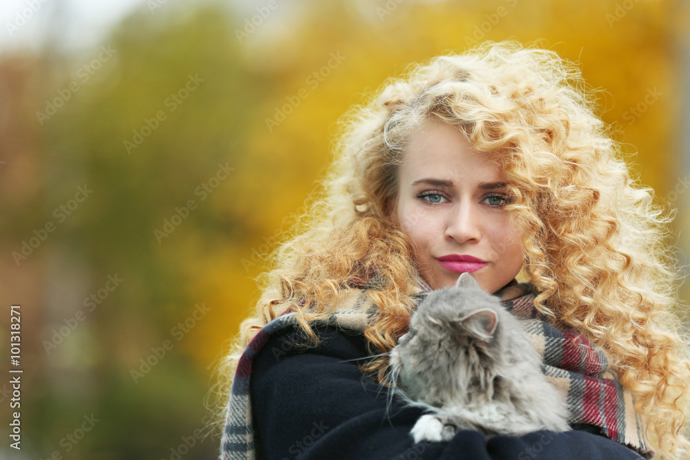 Young woman and cat in the park