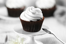 Delicious Chocolate Cupcake With Cream On Served Table, Close Up
