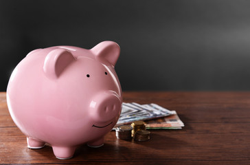 Piggy bank on a table with coins