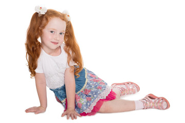 Little girl with red hair sitting