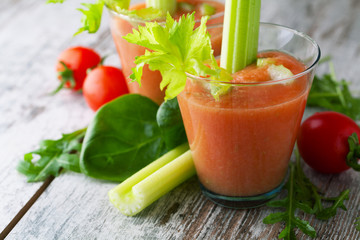 Sticker - Fresh smoothies tomato and celery on a  wooden background