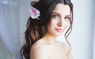 Portrait of beautiful bride model with perfect makeup and hair style in light room in a morning