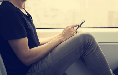 young man using a smartphone in a train or a subway