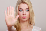 Fototapeta  -  Girl showing stop hand sign gesture.