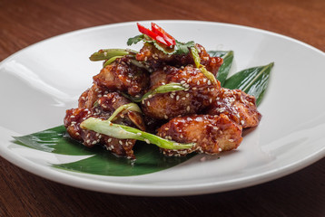 chicken fillet in tomato sauce with sesame seeds, chili