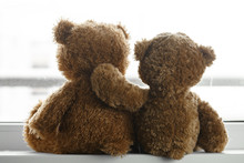 Two Teddy Bears Sitting Back