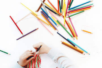 Child makes painting on white paper