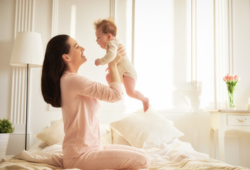 Wall Mural - mother playing with her baby