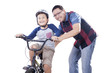 © Creativa Images - Dad helps his child to ride a bicycle