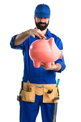 Wall Mural - Plumber holding a piggybank