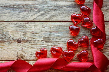 Wall Mural - Valentine's Day background with scarlet ribbon, glass heart