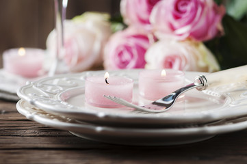 Wall Mural - Pink candle and roses on the table