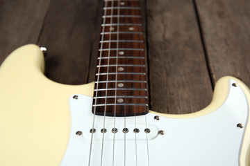 Wall Mural - Electric guitar on wooden background, close up