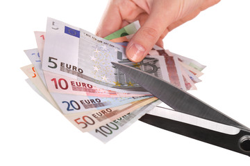 Poster - Hands with scissors cutting Euro banknotes, isolated on white