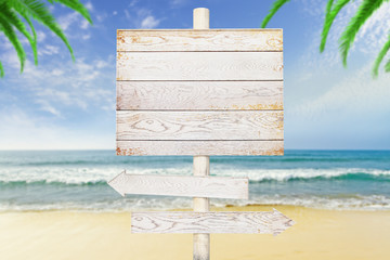 Wooden arrow signs on beach background