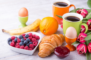 Wall Mural - Sweet healthy breakfast with coffee, eggs, croissant and berries 