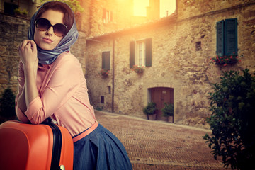 Woman with a suitcase travel  on street of italian city