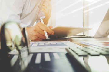 business documents on office table with laptop computer and grap