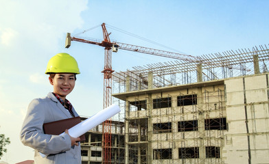 Wall Mural - portrait women asia engineer working and holding blueprints at c