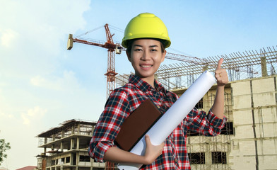 Wall Mural - portrait women asia engineer working and holding blueprints at c