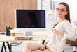 © shefkate - Young woman working in office, sitting at desk