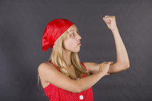 Young Girl Posing Like Rosie The Riveter In A Classic World War II Poster (We Can Do It)