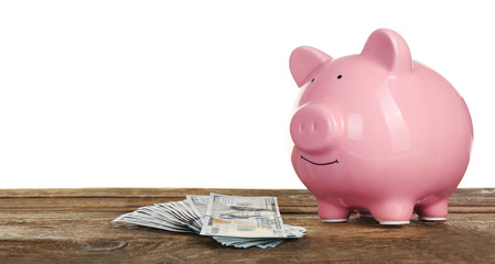 Poster - Piggy bank with banknotes on wooden table, isolated on white