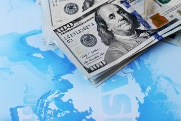 Wall Mural - Cash on the world map background, close up