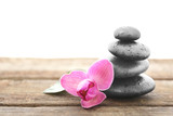 Fototapeta Storczyk - Spa stones with purple orchid on white background