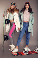 Wall Mural - two beautiful skier girls wear ski equipment