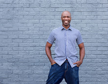 Confident African Man Smiling Against Gray Background