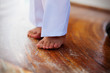 Baby's feet on the wooden brown floor
