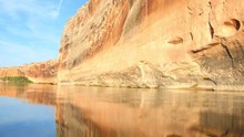 Water Ripples In Front Of The Red Rocks Of The Green River In Southeastern Utah.
