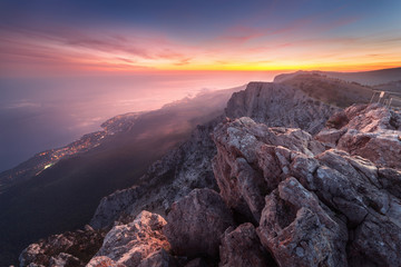 Wall Mural - beautiful landscape on the top of mountains with sea, colorful sunset and low clouds. nature backgro
