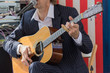 © R - Wooden guitar in musician hands