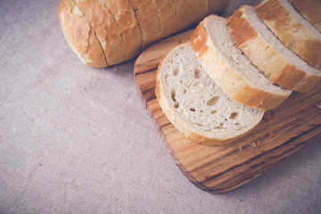 Sliced sourdough bread on wooden board,toning