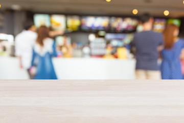 Plank wood or table top with blurred food shop background : Can use for montage or display your product background.