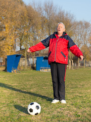 Wall Mural - Senior man playing football