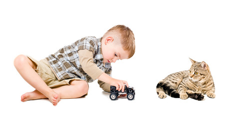 Beautiful boy playing toy car together with cat