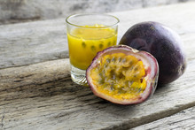 Passion Fruits With Glass Of Passion Fruit Juices On Wooden