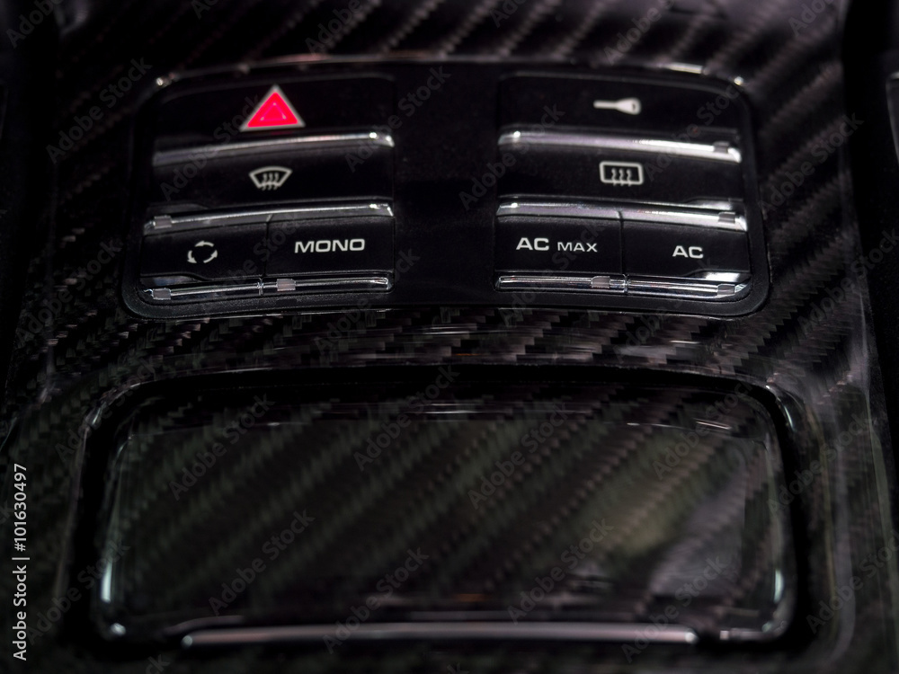 Saloon cars made of carbon fiber. White icons on black buttons in the ...