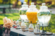 Glass jars of lemonade and decor on wedding candy bar