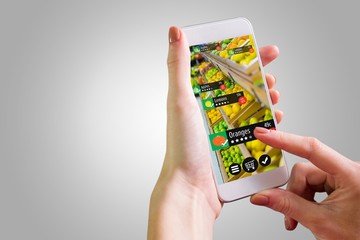 Composite image of hand holding smartphone