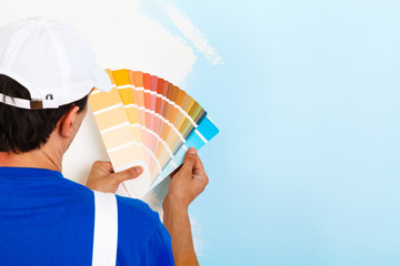 Wall Mural - painter man looking a color palette