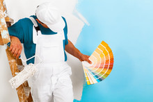 Painter  With Paintroller Showing A Color Palette