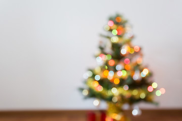 blur light celebration on christmas tree with white wall