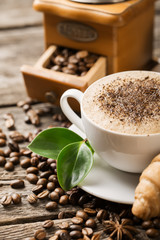 Wall Mural - hot coffee and coffee beans on the background of coffee grinders